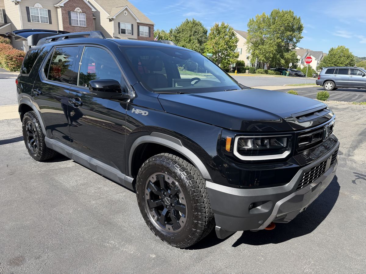 Glossy black Honda Passport after a mobile detail, parked in a sunny driveway