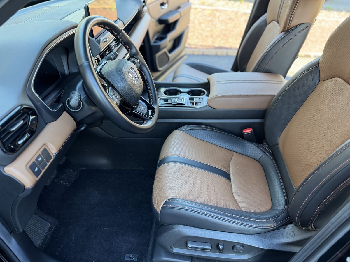 Honda Passport front seats after interior detailing, conditioned tan and black leather