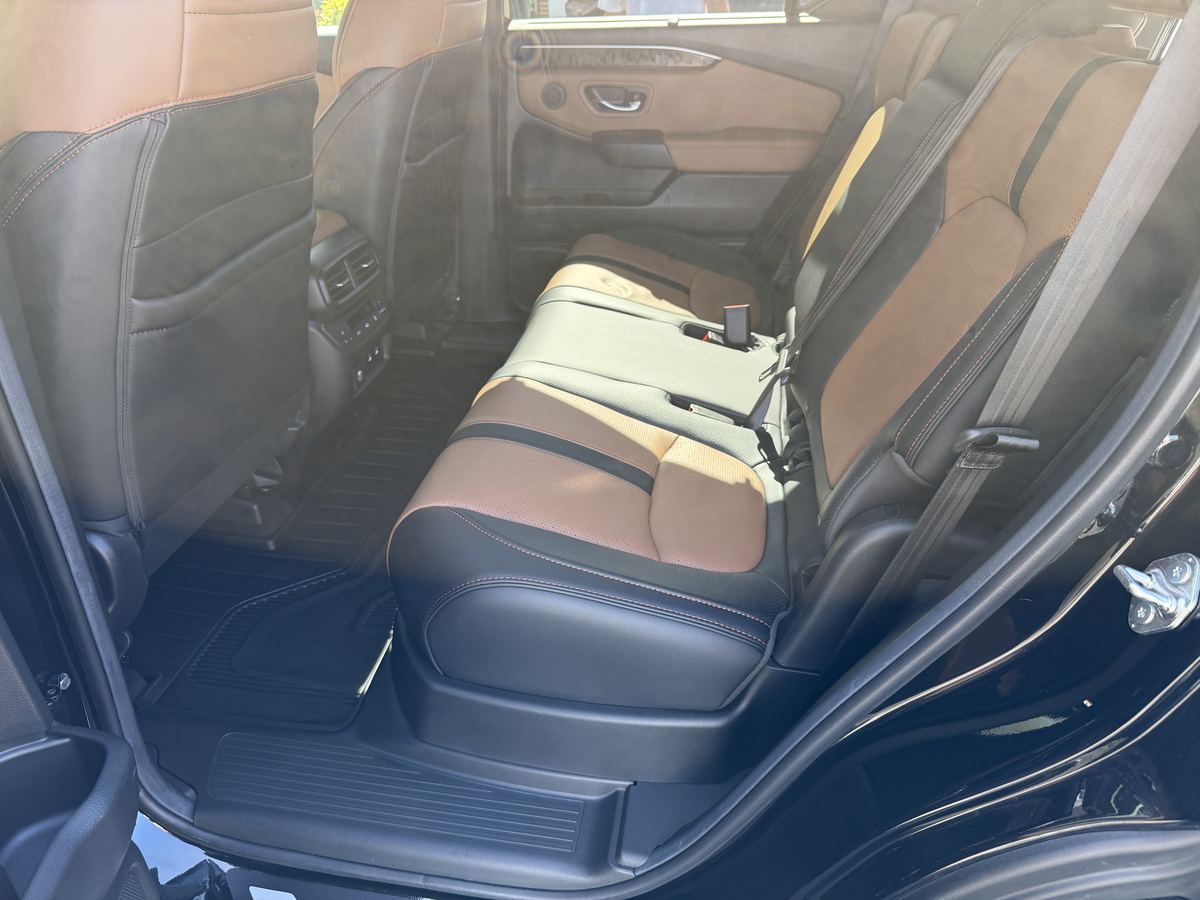 Honda Passport second-row seats after interior detailing, clean tan leather and floor mats