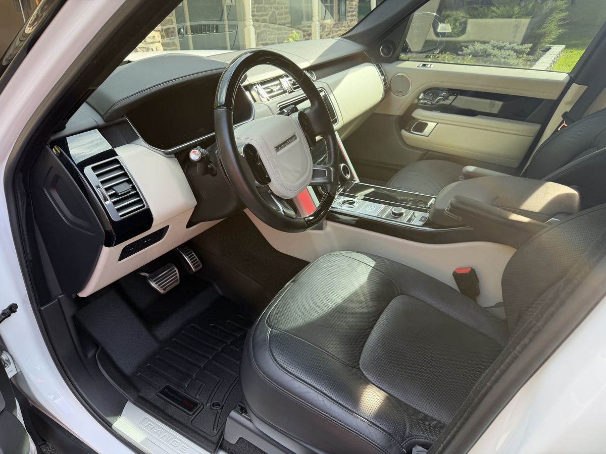 Range Rover front seats and dashboard after interior detailing, conditioned black leather