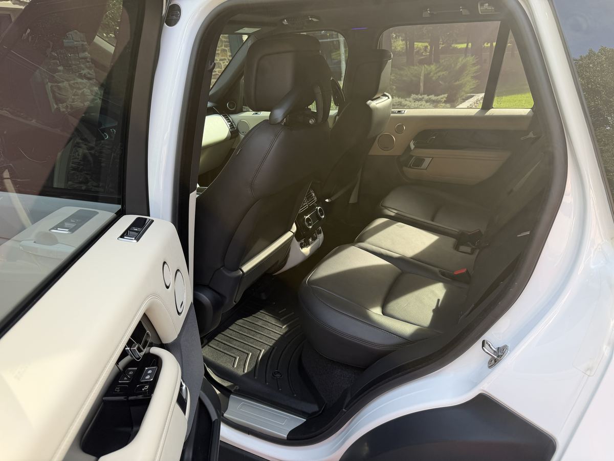Range Rover rear seats after interior detailing, clean black leather and door panels
