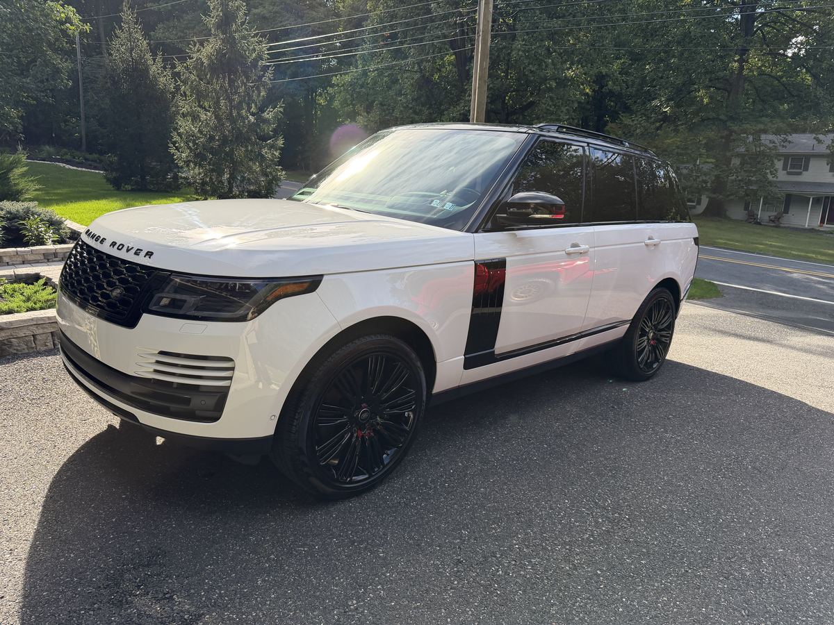 Front of the detailed white Range Rover showing clean grille, headlights and hood