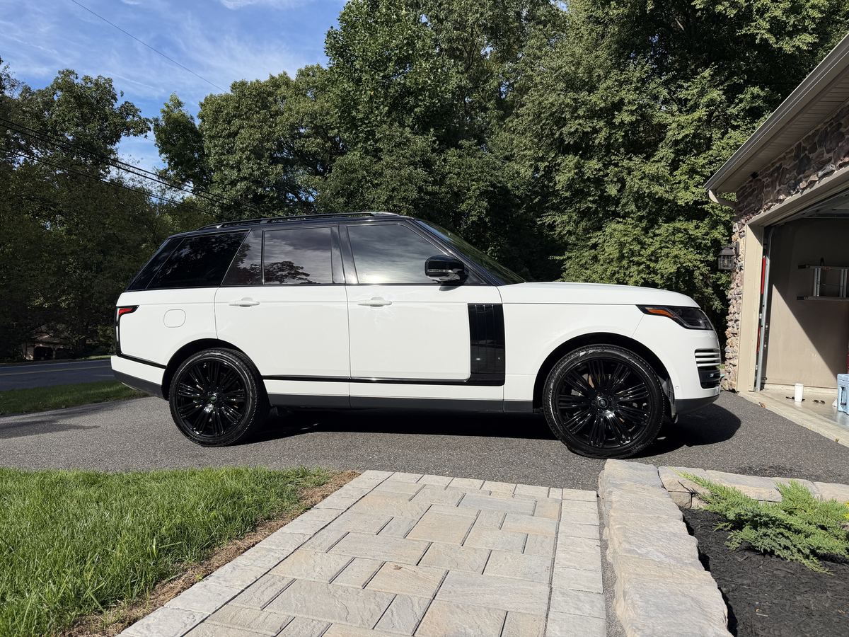 White Range Rover with black roof, side profile after detailing